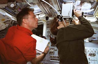 Flight deck activity during flyaround of Mir Space Station 